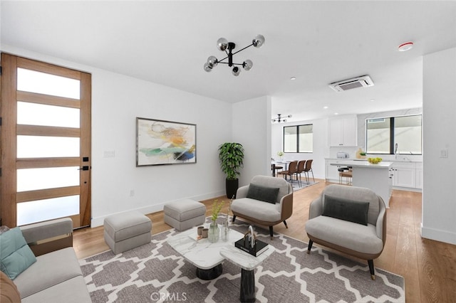 33851 Malaga Dr, Dana Point, CA 92629 - living room featuring light wood finished floors, baseboards, and a chandelier