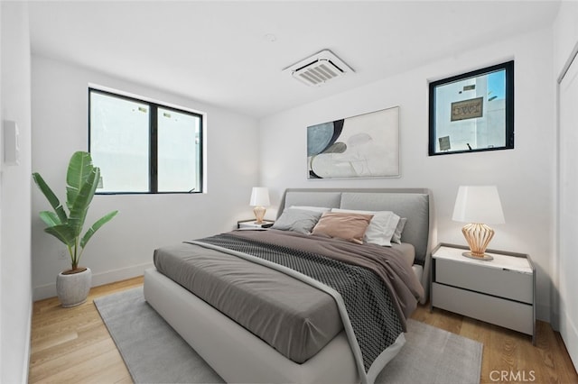 bedroom with light hardwood / wood-style floors