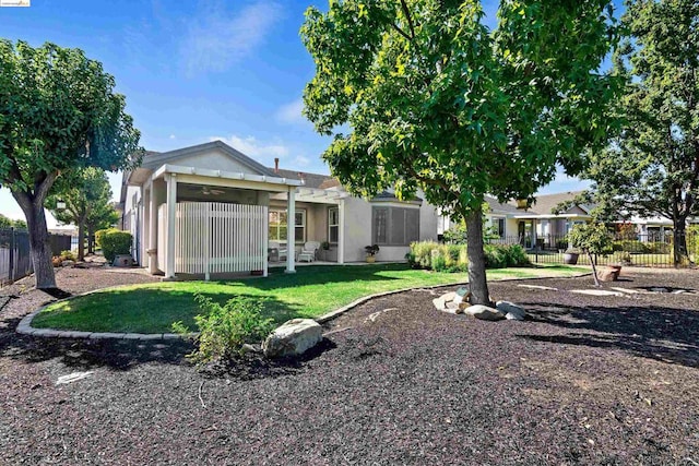 rear view of property with a yard