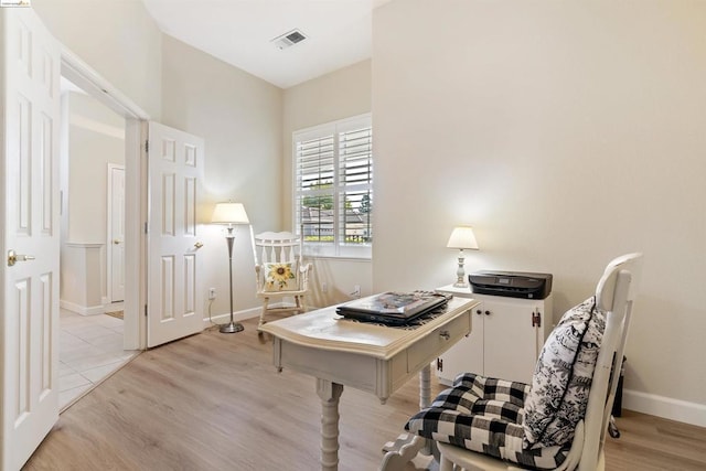 office with light hardwood / wood-style floors