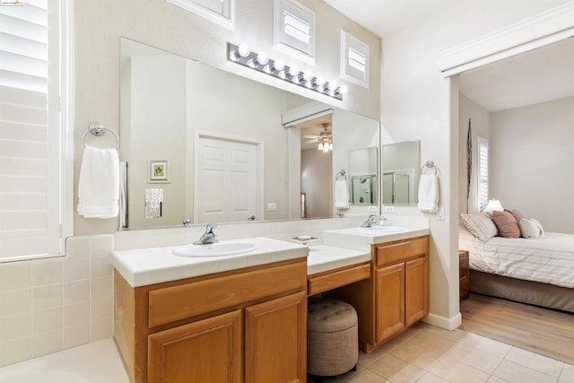 bathroom with ceiling fan, tile patterned flooring, and vanity