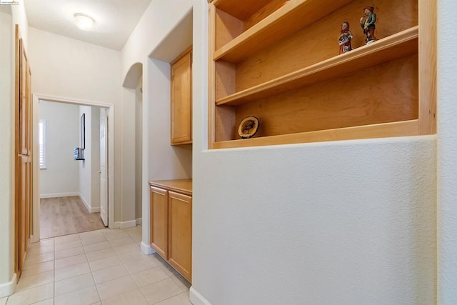 corridor with light tile patterned floors