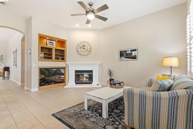 living room with ceiling fan and light tile patterned floors