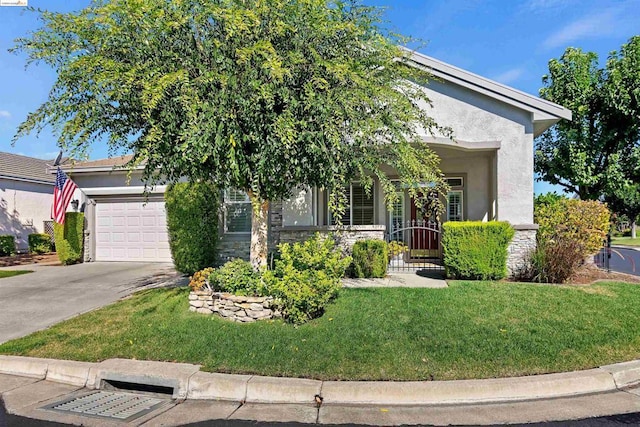 view of property hidden behind natural elements with a garage and a front yard