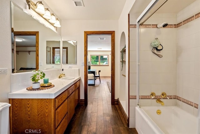 bathroom featuring shower with separate bathtub, vanity, and hardwood / wood-style floors