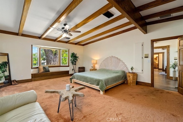 bedroom with ceiling fan, vaulted ceiling with beams, and carpet flooring