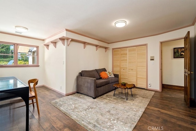 living room featuring ornamental molding and dark wood-type flooring