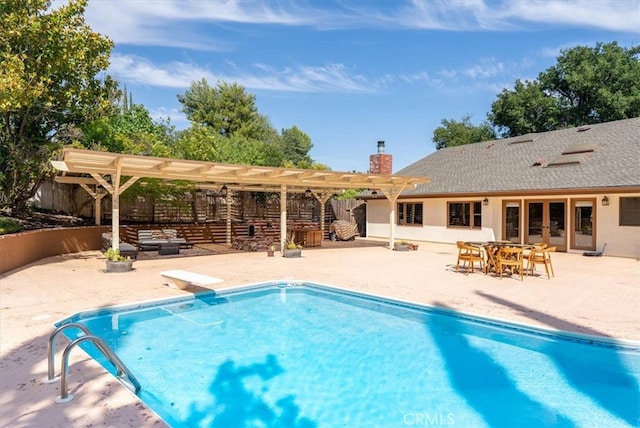 view of swimming pool with a pergola, a patio area, and a diving board