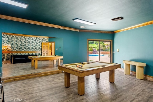 recreation room with pool table, wood-type flooring, a textured ceiling, and ornamental molding