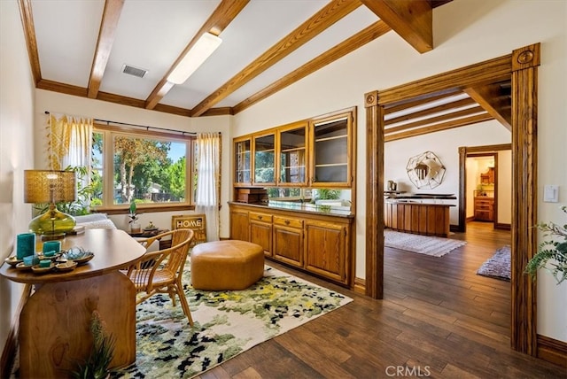 living area featuring lofted ceiling with beams and dark hardwood / wood-style flooring