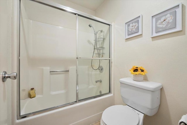 bathroom with enclosed tub / shower combo and toilet