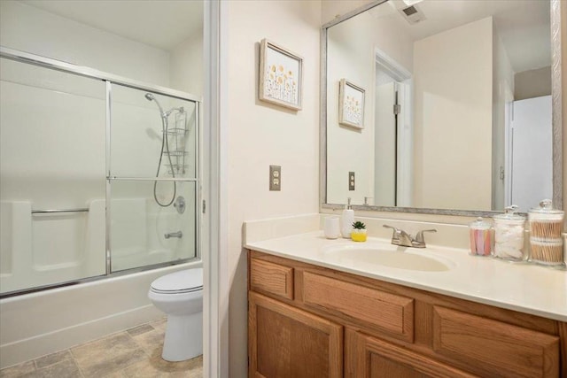 full bathroom with vanity, shower / bath combination with glass door, and toilet