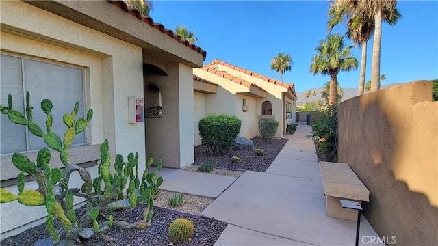 view of side of home with a patio area