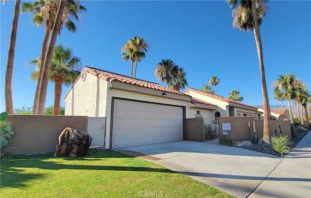 view of front of property featuring a front lawn and a garage