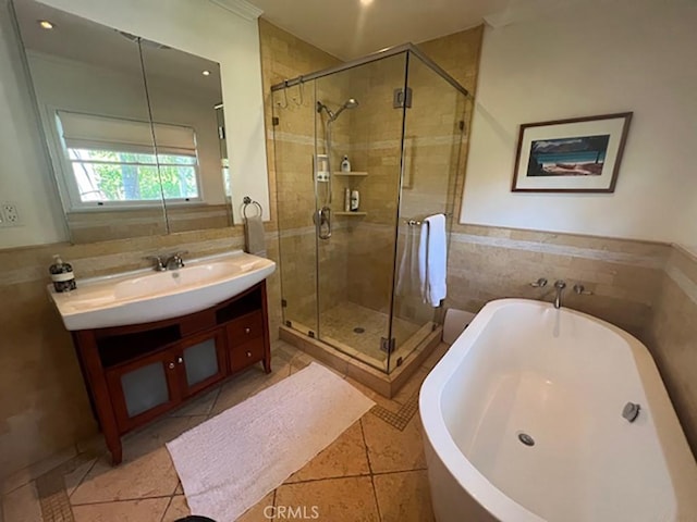 bathroom with separate shower and tub, tile patterned flooring, vanity, and tile walls