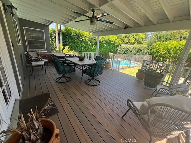 wooden terrace featuring a pool and ceiling fan