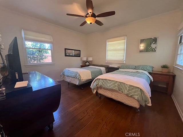 bedroom with dark hardwood / wood-style floors, ceiling fan, and ornamental molding