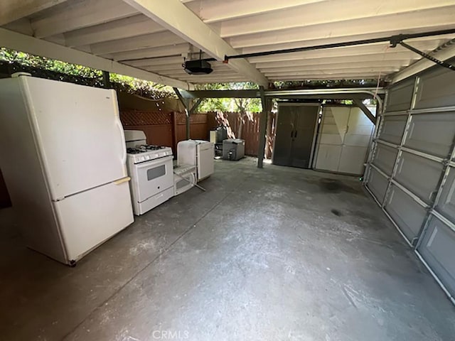 garage with white refrigerator and a garage door opener