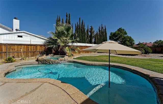 view of swimming pool featuring a yard and an in ground hot tub