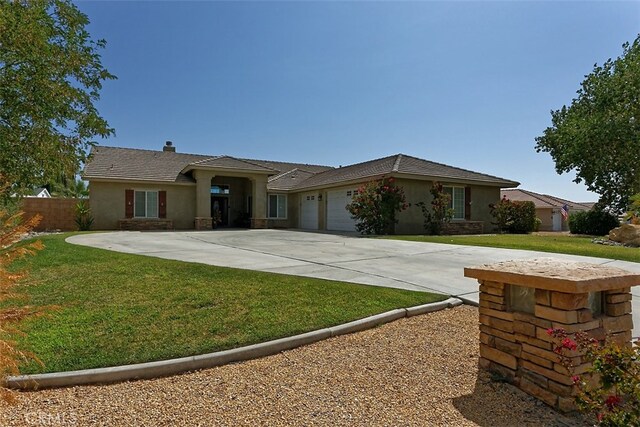 single story home featuring a front yard and a garage