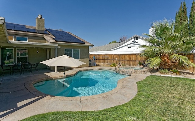 view of swimming pool with an in ground hot tub, a patio area, and a lawn