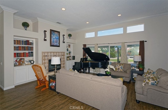 living room featuring crown molding, built in features, and dark hardwood / wood-style flooring