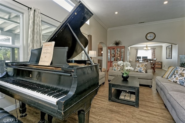 misc room featuring a notable chandelier, hardwood / wood-style flooring, and crown molding