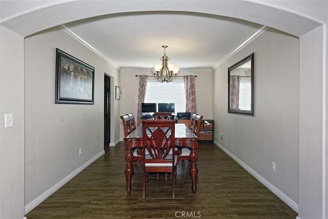 dining space featuring ornamental molding, a chandelier, and dark hardwood / wood-style flooring