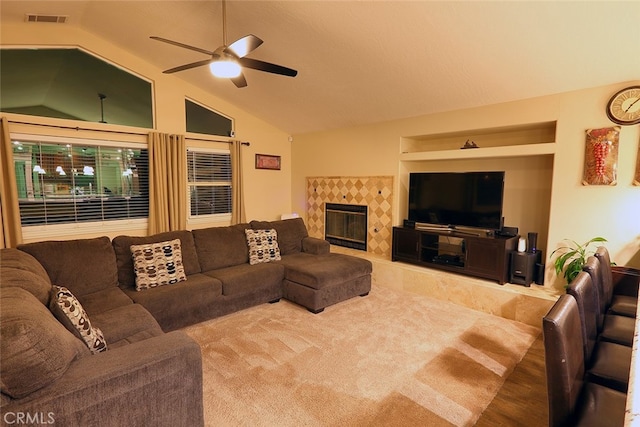 living room with lofted ceiling, a fireplace, and ceiling fan