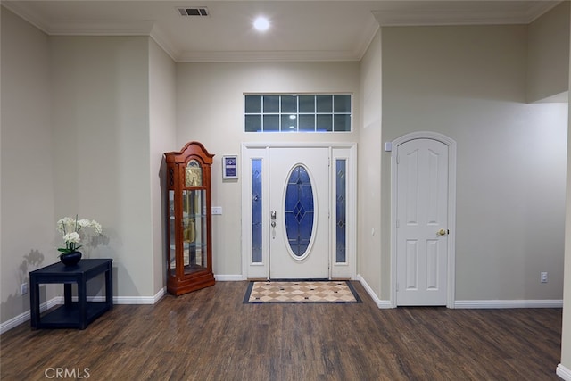 foyer entrance with ornamental molding and dark hardwood / wood-style flooring