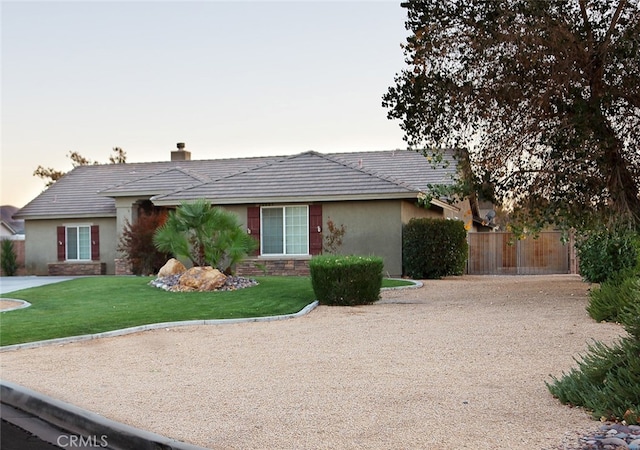 ranch-style house with a lawn