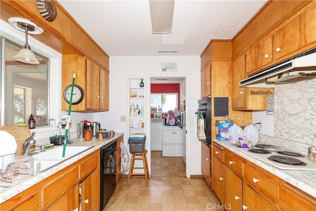 kitchen featuring independent washer and dryer, black appliances, pendant lighting, and backsplash