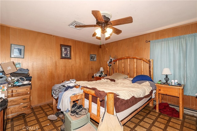 bedroom with wooden walls and ceiling fan