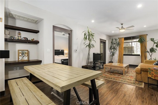 dining area with ceiling fan and wood-type flooring