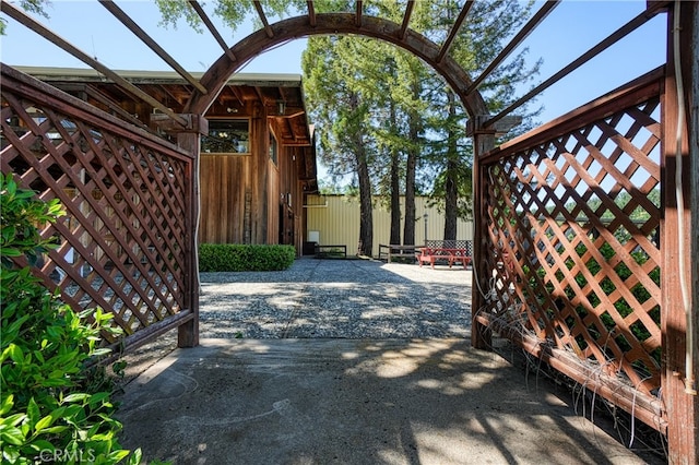 view of gate with a patio