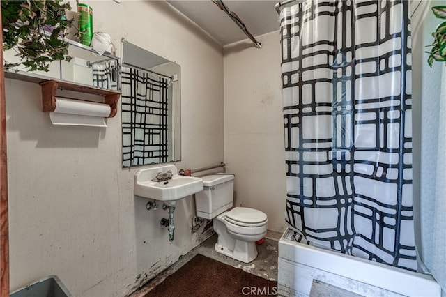 bathroom with walk in shower, sink, and toilet