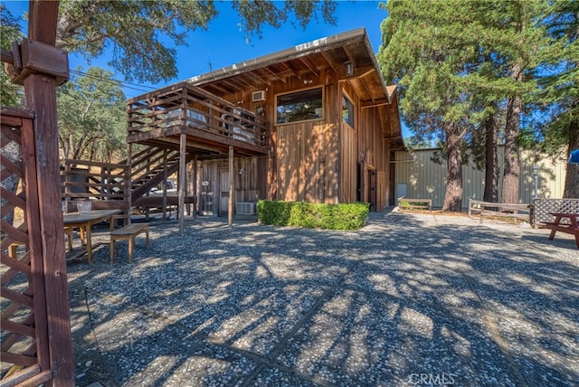 exterior space featuring a wooden deck and central AC