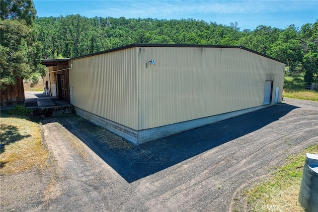 view of side of home featuring an outbuilding