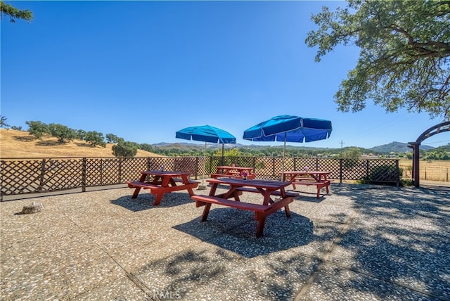 exterior space featuring a mountain view and a patio area