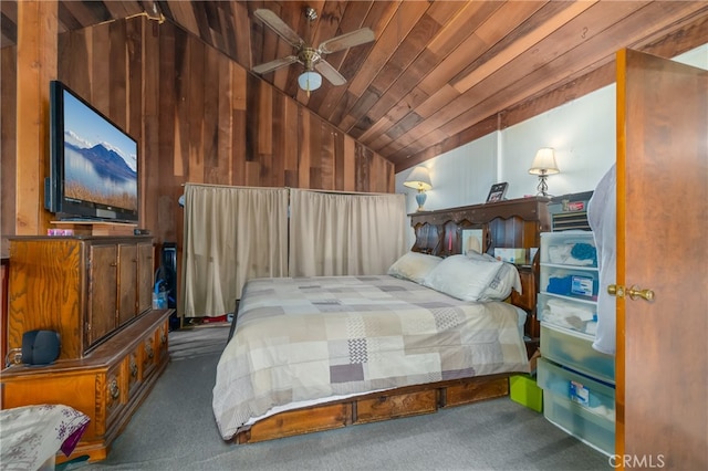 carpeted bedroom featuring lofted ceiling, ceiling fan, wood walls, and wooden ceiling