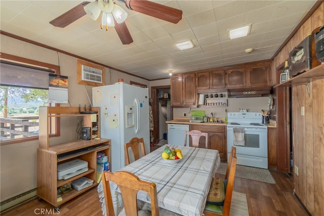 kitchen featuring dark wood-type flooring, sink, an AC wall unit, white appliances, and crown molding