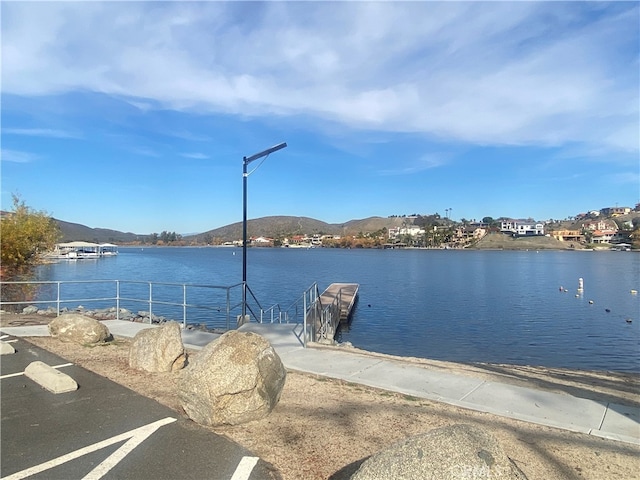 water view with a mountain view and a boat dock