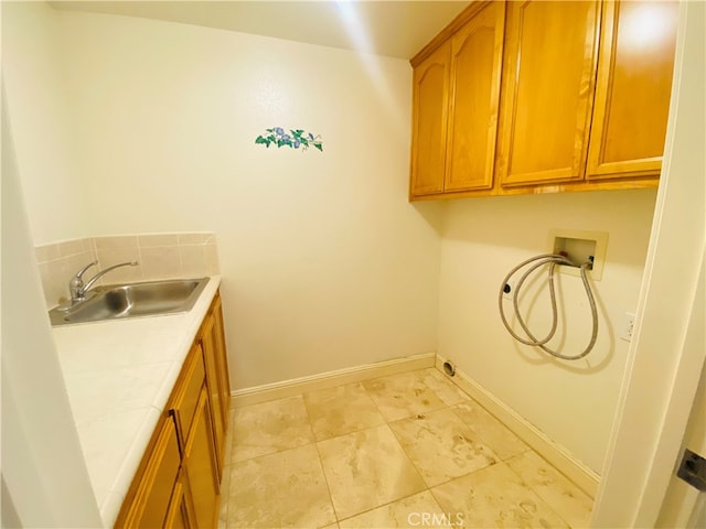 laundry area with sink, washer hookup, and cabinets