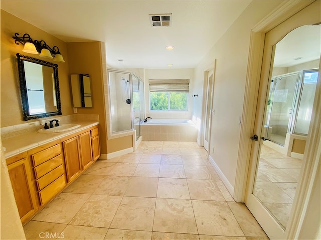 bathroom with vanity, plus walk in shower, and tile patterned flooring