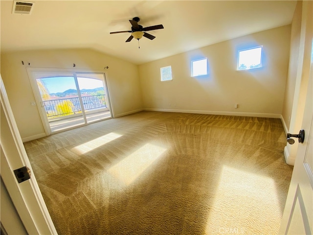 carpeted spare room with vaulted ceiling and ceiling fan