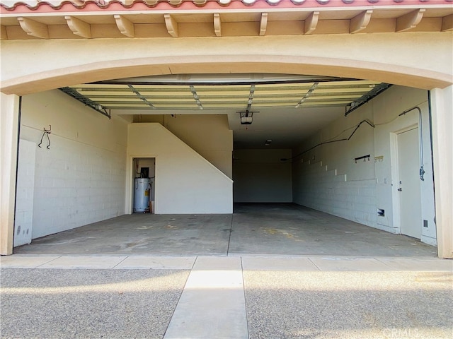 garage with water heater and a garage door opener