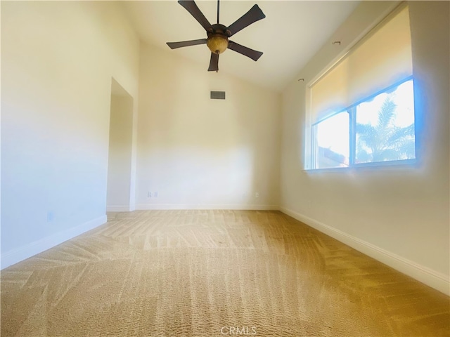 carpeted empty room with vaulted ceiling and ceiling fan