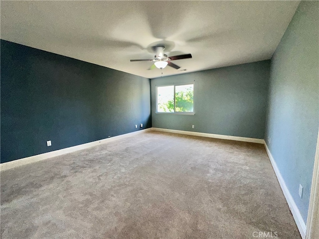 unfurnished room featuring a textured ceiling, carpet flooring, and ceiling fan