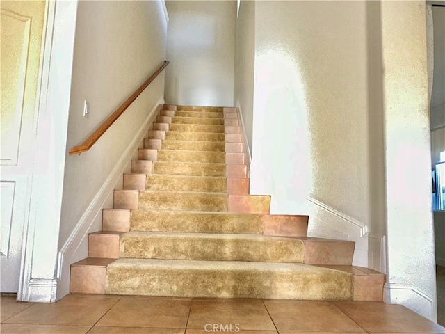 stairs with tile patterned floors