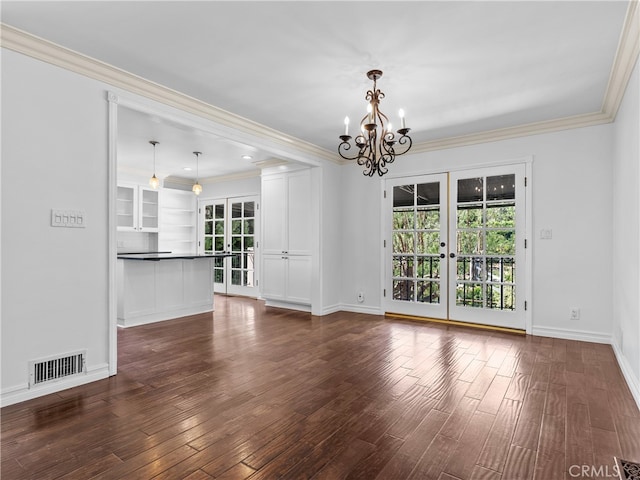 unfurnished living room featuring ornamental molding, dark hardwood / wood-style flooring, french doors, and a notable chandelier